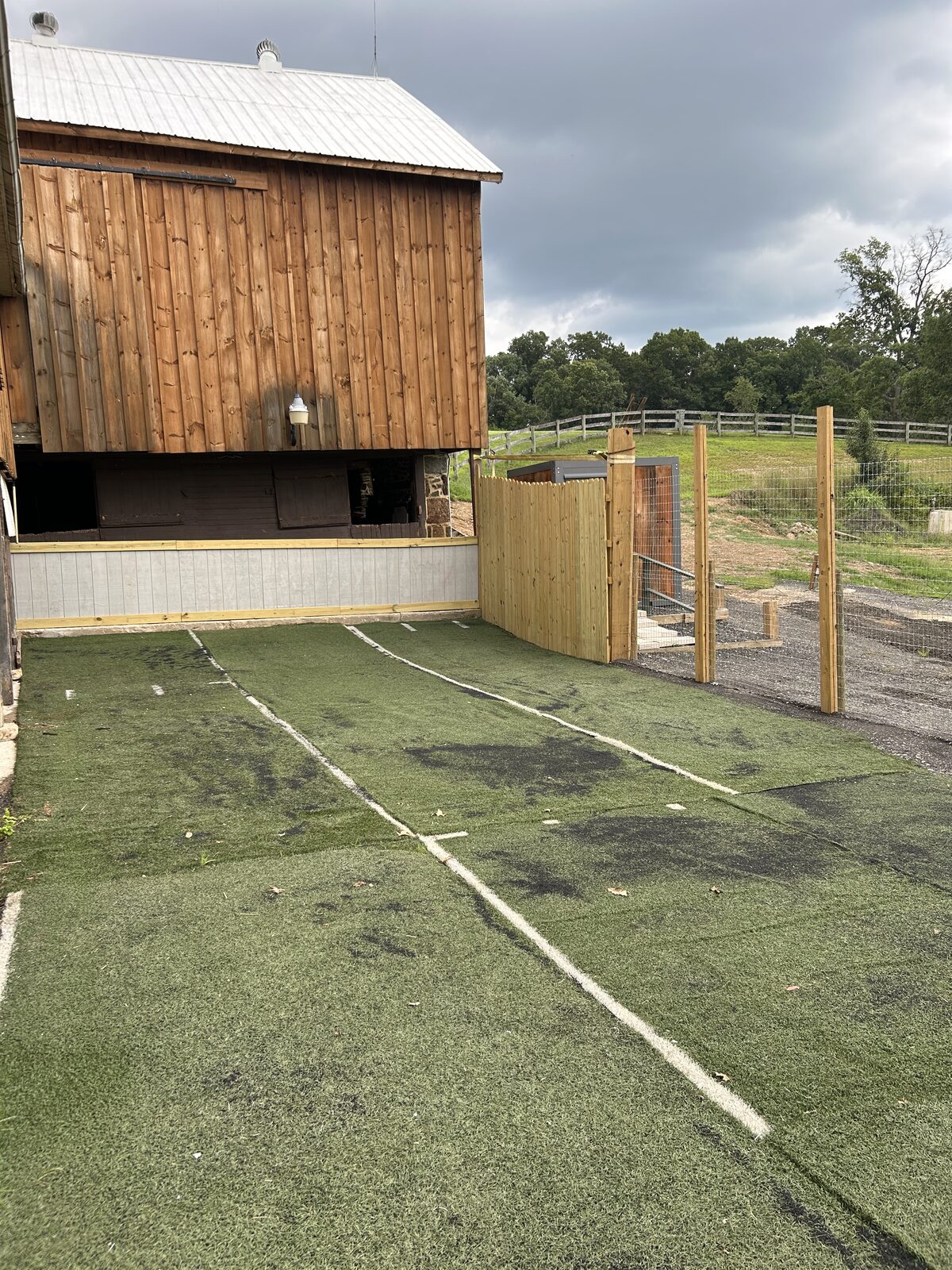 Indoor-outdoor barnyard play area with artificial turf